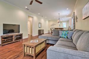 a living room with a couch and a tv at Lovely Mobile Retreat with Deck and Front Porch! in Mobile
