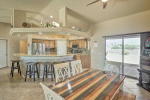 a kitchen with a bar with stools in it at Lake Havasu Getaway about 2 Mi to London Bridge! in Lake Havasu City