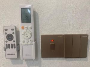 a nintendo wii game system with a controller and a box at Kota Permai Mini Rest Room 99 Full Equipped in Bukit Mertajam