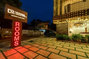 a sign in front of a building with lights at Daan Regency in Trichūr