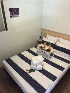 a hotel room with two beds with a tray of food at Happy Home in Biograd na Moru