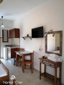 a living room with a table and a mirror at Avra Ηouse in Kriopigi