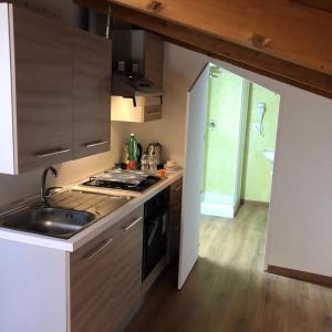 a kitchen with a sink and a stove top oven at Emma's house in Sorrento