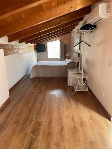 a bedroom with a bed and a wooden floor at Emma's house in Sorrento