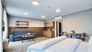 a bedroom with a bed and a couch at ABA Apartments in Olomouc