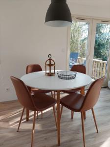 a dining room with a white table and chairs at Erfgoed de Boemerang - Chalet Schaap in Meppen
