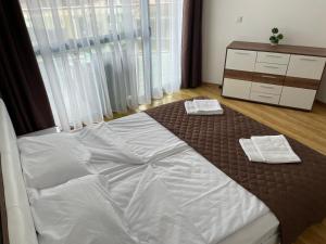 a bedroom with a bed with two towels on it at Spacious and cozy Apartment in complex Del Sol in Primorsko +13 photos