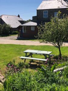 a picnic table in the grass in front of a house at The Annexe at Pridden in Saint Buryan
