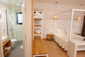 a bedroom with a bed and a sink and a mirror at Alex & Sofi Hotel in Himare +281 photos