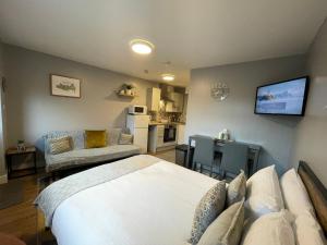 a bedroom with a bed and a living room at Westend Holiday Let 4 Brecon in Brecon