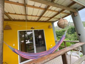 a hammock hanging from the porch of a house at Berton Place in Providencia