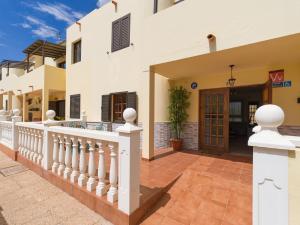 a house with a white fence and a porch at Vv Casa Maruca Accesibilidad - Playa 5 min in Caleta De Fuste