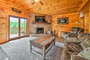 Una sala de estar con un sofá y una chimenea. en Gatlinburg Cabin with Home Theater and Hot Tub!, en Gatlinburg