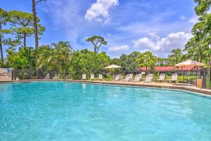 einen Pool in einem Resort mit Stühlen und Bäumen in der Unterkunft Sunny Sarasota Villa with Lanai Less Than 5 Mi to Beach in Sarasota