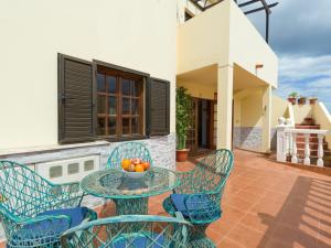 a patio with a table and chairs and a bowl of fruit at Vv Casa Maruca Accesibilidad - Playa 5 min in Caleta De Fuste