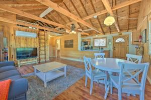 a dining room and living room with a table and chairs at Payson Cabin with Deck Views of the Mogollon Rim! in Payson