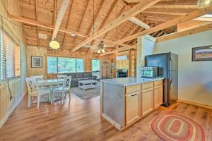 a kitchen and living room with a table and chairs at Payson Cabin with Deck Views of the Mogollon Rim! in Payson