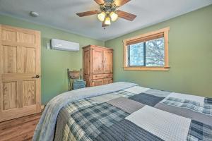 a bedroom with a bed and a ceiling fan at Payson Cabin with Deck Views of the Mogollon Rim! in Payson