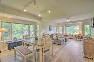 a dining room and living room with a table and chairs at North Myrtle Beach Condo with Golf Course Views in North Myrtle Beach