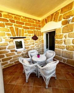a patio with a table and wicker chairs at La Casa di Ninì in Agrigento