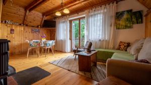 a living room with a couch and a table at Holiday house Nature in Ravna Gora