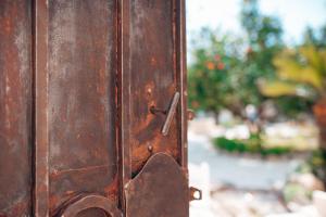 a close up of a metal door with a lock at Tenuta Tresca Suites - Dimora Storica in San Cassiano