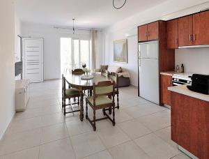 a kitchen and living room with a table and chairs at Almira Ghouse in Almiropotamos