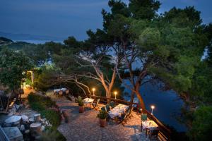 a restaurant with tables and chairs at night at Accomodation STERMASI in Maranovići
