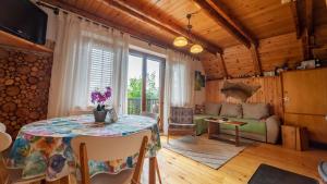 a living room with a table and a couch at Holiday house Nature in Ravna Gora +19 photos