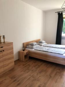 a bedroom with a bed and a wooden floor at Víkendový dom - Divín in Divín