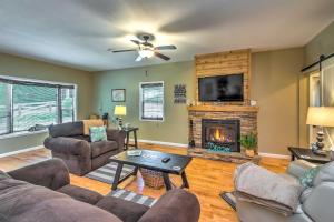 a living room with a couch and a fireplace at Country Cottage Less Than 3 Mi to Dale Hollow Lake! in Byrdstown