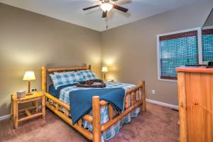 a bedroom with a wooden bed and a ceiling fan at Country Cottage Less Than 3 Mi to Dale Hollow Lake! in Byrdstown