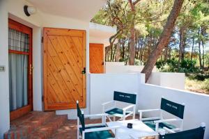 a front door of a house with a table and chairs at Hotel Kyrie Isole Tremiti in San Domino