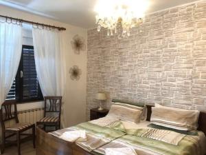 a bedroom with a brick wall and a bed at Istrian house Mojca in Koper
