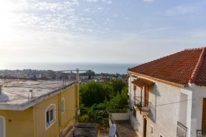 a view of the ocean from the roofs of buildings at Prana's Castle in Kyparissia