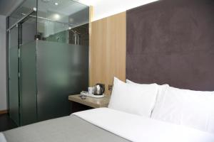 a bedroom with a white bed and white walls at The Z Hotel Piccadilly in London