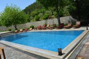 a large swimming pool with chairs at Hotel&Restaurant Aroma in Përmet