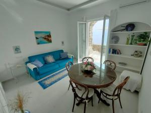 a living room with a table and a blue couch at Positanobay in Positano