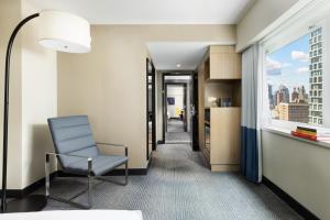 a room with a chair and a window at M Social Hotel Times Square New York in New York