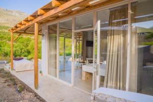 a glass house with a view of a patio at Bungalows Panstel in Kerames Rethymno in Agia Paraskevi