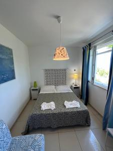 a bedroom with a bed with two towels on it at Casette Santini B&B in Casalbordino