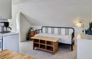 a bedroom with a bed and a wooden table at Stunning Apartment In Gullspng With Wifi in Gullspång