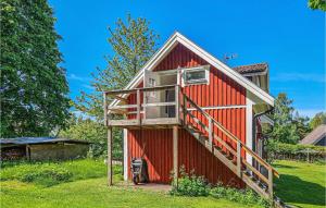a red barn with a balcony on the side of it at Stunning Apartment In Gullspng With Wifi in Gullspång