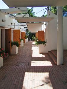 an empty hallway of a white building with awning at Hotel Kyrie Isole Tremiti in San Domino