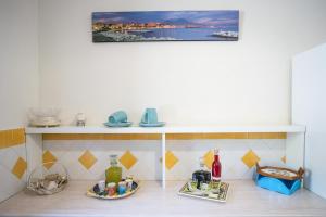 a kitchen with a shelf with dishes on it at Casa Vacanza La Gardenia in Tramonti