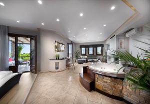 a large living room with a tub in the middle at Iakovakis Suites & Spa in Koropi