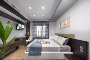 a bedroom with a bed and a desk at Iakovakis Suites & Spa in Koropi
