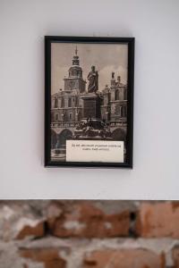 a framed picture of a building on a wall at Sarego PREMIUM Apartament in Kraków