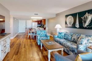 a living room with a couch and a table at 103 - Sandy Shores in St. Pete Beach