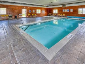 a large swimming pool with blue water in a building at Yellowstone River Inn & Suites in Livingston